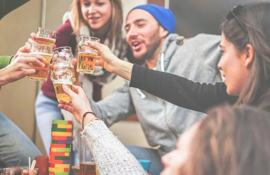 Group of friends toasting and cheering with glasses of beer