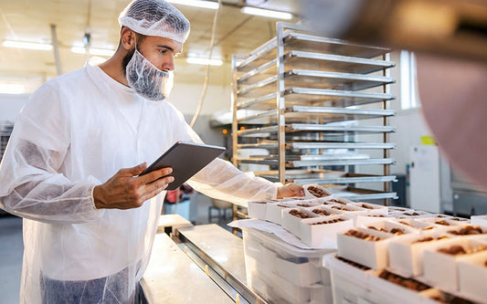 Food inspector performing a quality check in a food processing facility