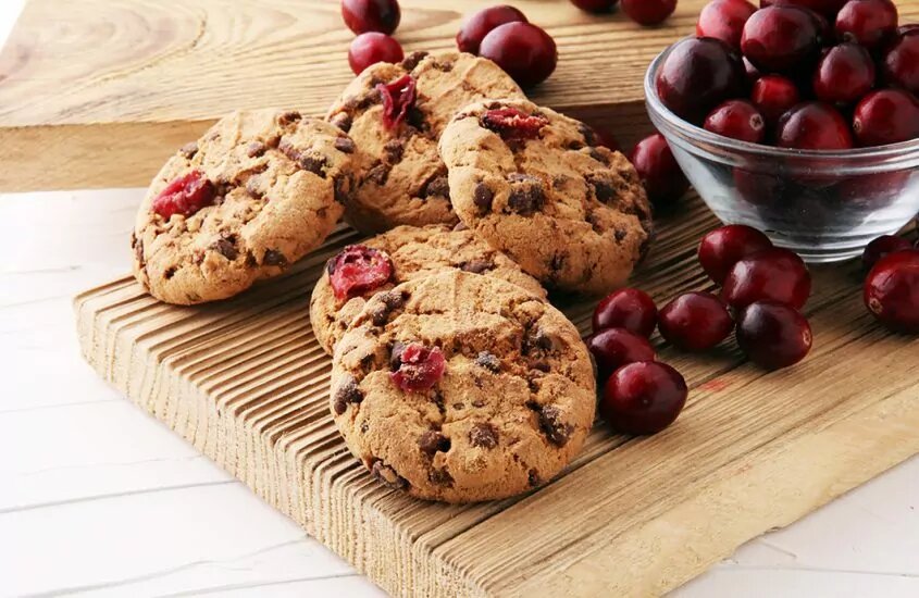 Cranberry cookies next to a bowl of cranberries
