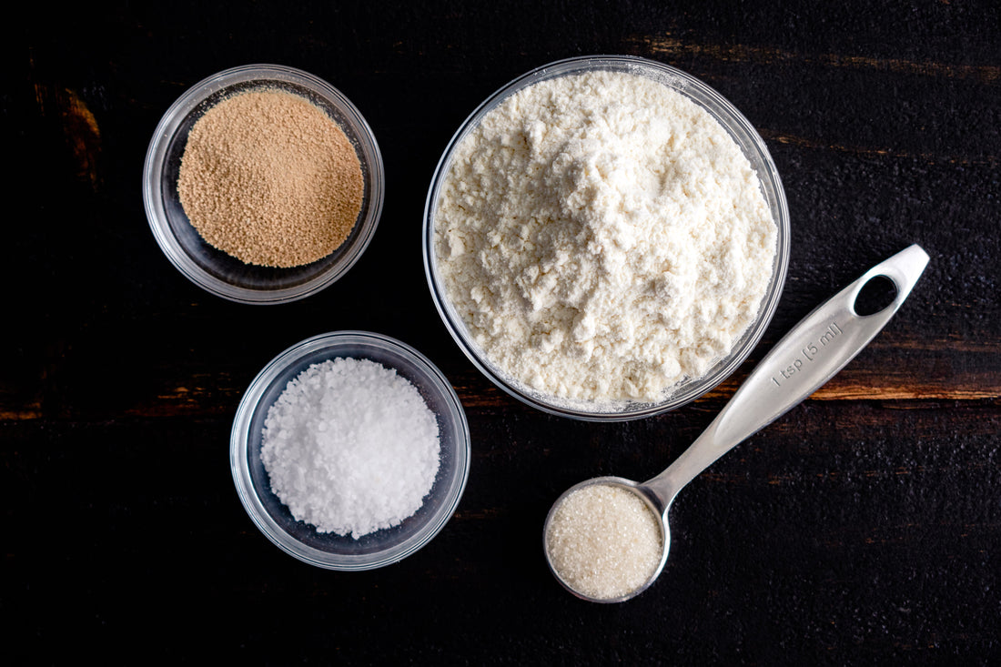 Bowls of flour, salt, yeast, and sugar.