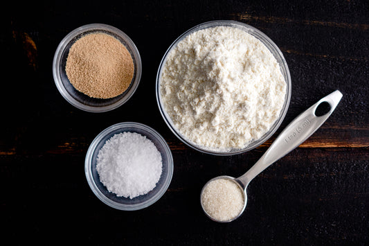 Bowls of flour, salt, yeast, and sugar.